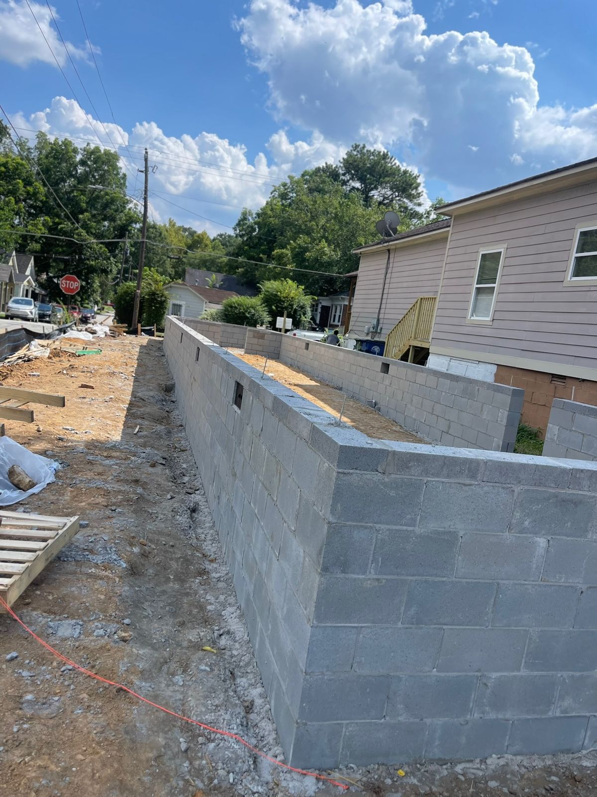 Concrete block foundation walls laid on the cleared corner lot